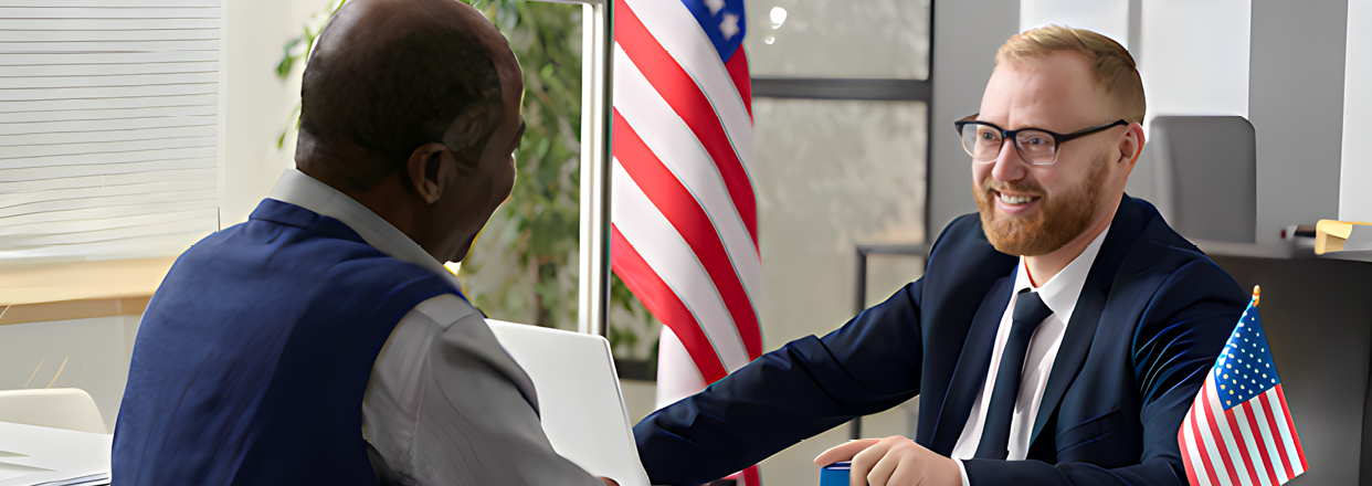 Two men are sitting at a desk, one wearing a suit and tie. The other man is wearing a suit and tie and has a beard. They are both looking at a computer screen. AI generated content