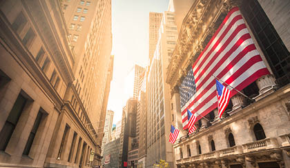 A large American flag is flown on a pole in front of a building. AI generated content