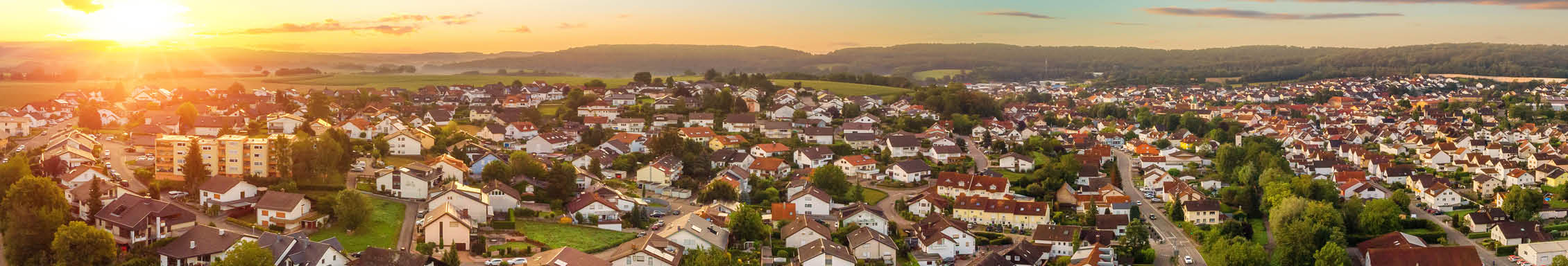 A series of pictures show a sunset over a town with houses and trees. AI generated content