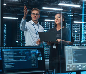 Three people are standing in front of a wall of computer screens. AI generated content